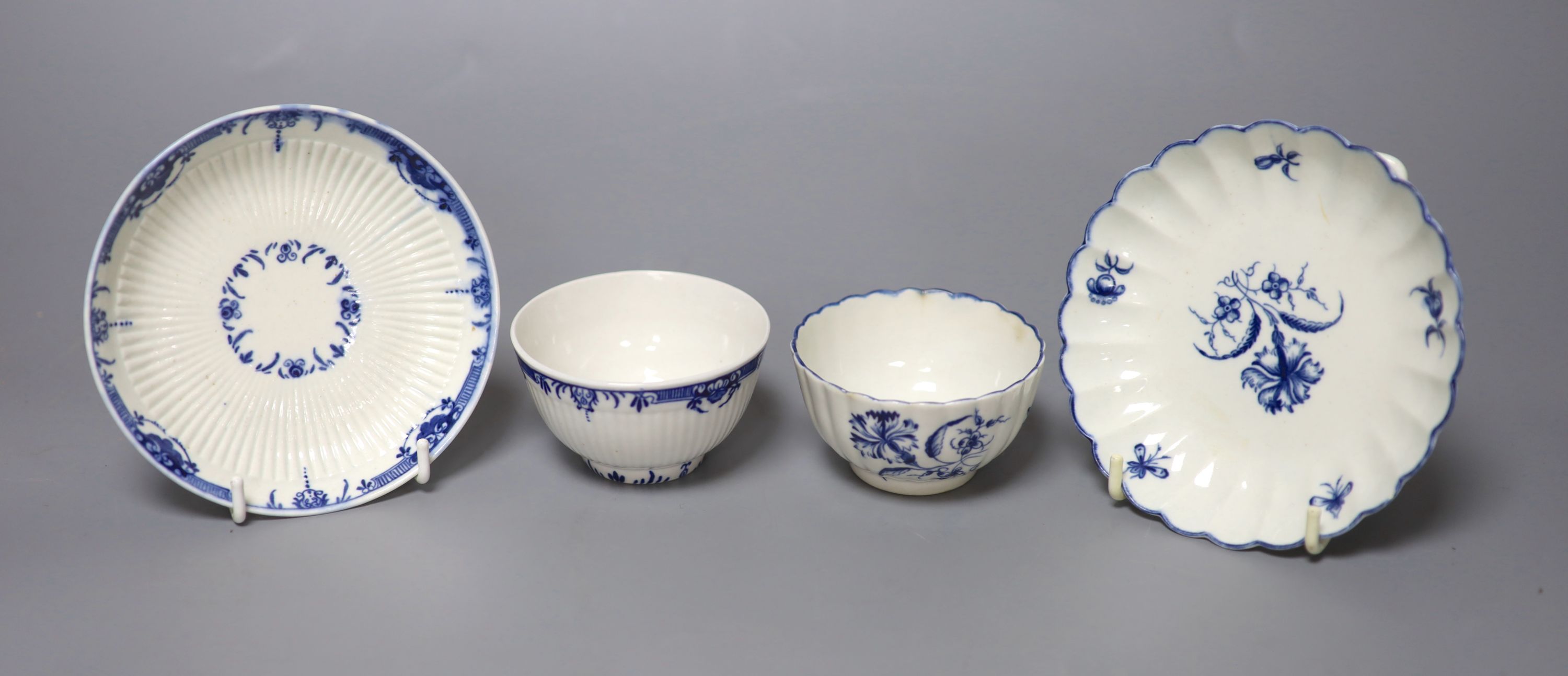 An 18th century Worcester fluted teabowl and saucer painted with the Gilliflower pattern and another teabowl and saucer with reed mould